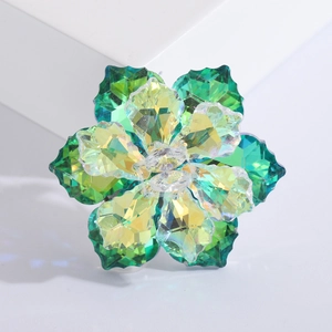 Macro detail of luxury crystal flower brooch with faceted green and yellow petals