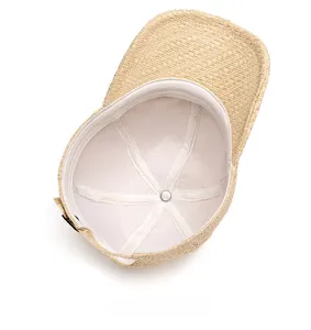 Internal view of a woven straw baseball cap featuring white lining and inner sweatband