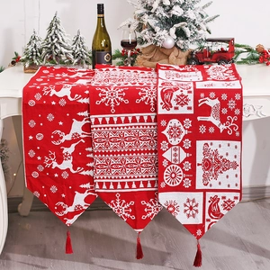 Christmas table runners with reindeer and snowflake patterns and red velvet tassels