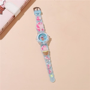 Detail of light blue silicone watch band with 3D cartoon unicorn and rainbow elements