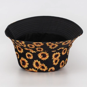 Detailed view of the vibrant sunflower print on a black outdoor bucket hat for sun protection