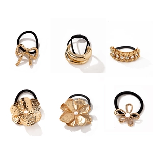 Elegant gold metal hair ties with pearl charms and bow designs for ponytails