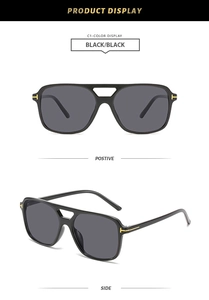 Detail of iconic gold T-shaped metal hinges on black square pilot sunglasses