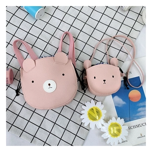 Detailed view of pink bear PU leather children's bags on a black and white checkered background