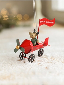 Close-up of a festive reindeer flying a red metal airplane with Merry Christmas banner