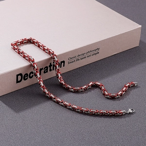 Close-up of red and silver 5mm stainless steel Byzantine chain necklace on neutral background