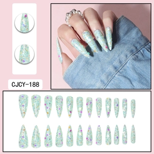 Detailed view of mint green stiletto press-on nails with colorful sequins and silver glitter