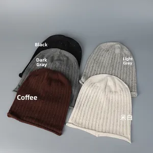 Flat lay detail showing five colors of breathable confetti knit beanies for women