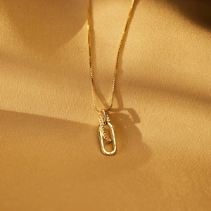 Macro detail of interlocking gold rings with LOVE engraving and pavé set white zircons