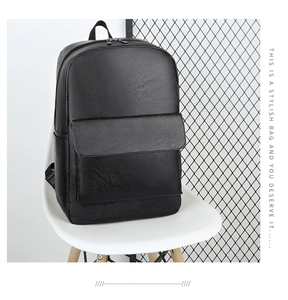 Close-up of black leather business backpack with lychee grain texture and zipper detail