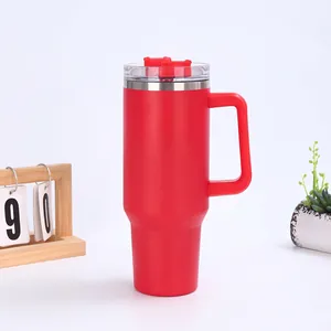 Detail of red 40oz insulated tumbler featuring ergonomic handle and transparent lid