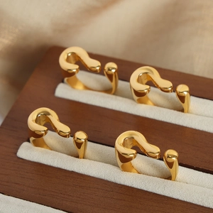 Elegant gold plated stainless steel question mark rings displayed in a luxury jewelry box