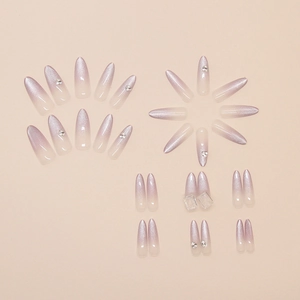 Detail of long almond cat-eye press-on nails with purple gradient and rhinestones