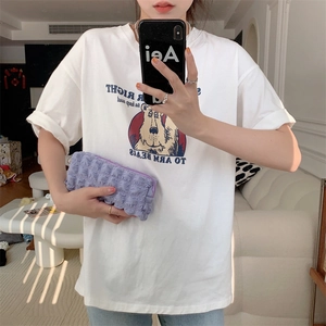 Detail view of a purple bubble pleated makeup bag paired with a white cotton bear t-shirt