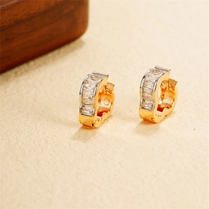 Macro view of gold U-shaped ear cuffs with rectangular clear zircon stone inlay