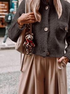 Chic dark grey knitted cardigan with wooden buttons paired with brown wide-leg trousers