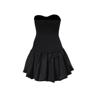 Detail of black strapless mini dress featuring a smocked bodice and satin flared skirt
