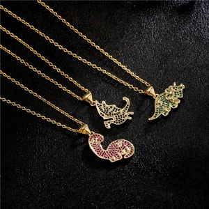 Hip hop dinosaur pendants in gold plating with green, black, and red zircon stones