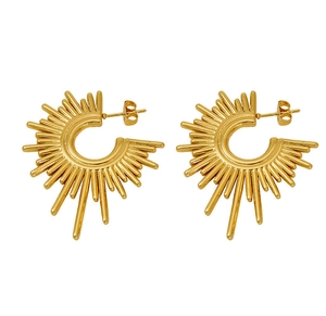 Detailed macro view of golden sunburst C-shape stud earrings with textured radial lines