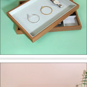 Detail view of solid wood jewelry display tray with soft grey velvet lining and dividers
