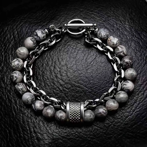 Detailed shot of men's bracelet with matte map stone beads and stainless steel Cuban chain