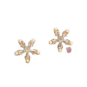 Elegant snowflake stud earrings with gold plating, sparkling zircons, and pearl accents