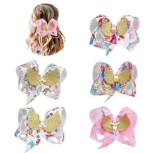 Detail of colorful children bow hair clips with glitter wings and cartoon animal charms