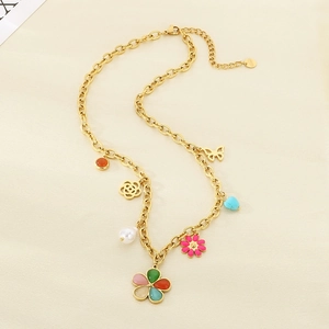 Detail of gold necklace with colorful enamel flowers, pearls and butterfly charms