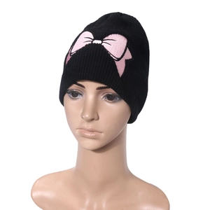 Black knit beanie with pink bow embroidery for winter warmth shown on mannequin