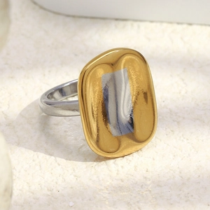 Macro detail of minimalist two-tone 18K gold plated stainless steel chunky ring