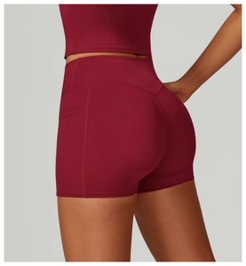 Detailed back view of high waist yoga shorts in burgundy with peach butt lifting seam