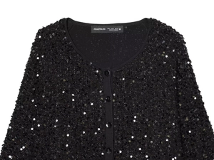 Macro detail of black sequin knit cardigan with V-neckline and round buttons