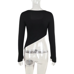 Detail of black long sleeve slim fit crop top featuring an asymmetric diagonal hemline