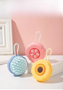 Detail of flower-shaped silicone scalp massager brushes with hanging loop and soft bristles