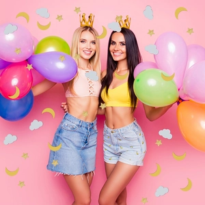 Colorful party decor set with moon star confetti and vibrant latex balloons in a festive scene