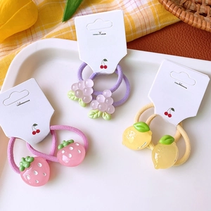 Cute fruit pendants on elastic hair ties with strawberry, grape, and lemon designs