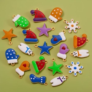 Christmas enamel charms in gold finish featuring snowflakes stars and holiday shapes