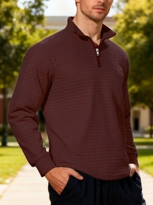 Detail of burgundy quarter-zip sweatshirt showing premium waffle texture and stand collar