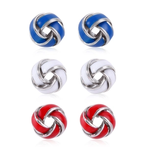Macro detail of zinc alloy woven knot earrings in blue, white, and red enamel finish