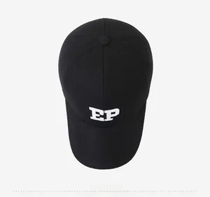Top view of black wool baseball cap featuring white EP embroidery and thick texture