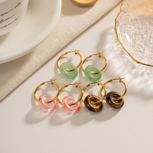 Three pairs of retro gemstone donut hoop earrings in green, pink and brown hues