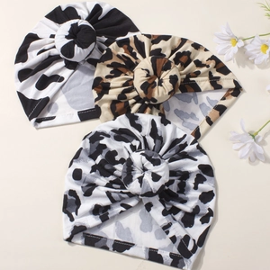Three-pack of infant knot beanies in cow and leopard prints for summer breathability