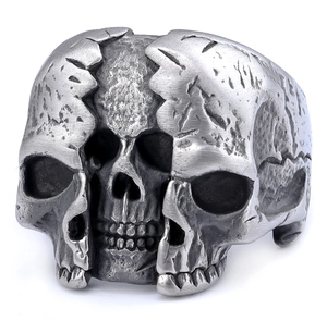 Detailed macro view of the distressed vintage skull ring with silver industrial finish