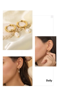 Detail of 18K gold plated hoop earrings with elegant white pearl drops on model