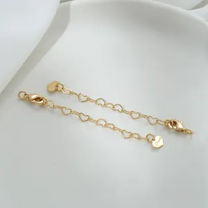 Macro view of 14K gold filled heart-shaped extender chains with Yours engraved tag