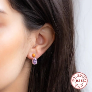 S925 sterling silver egg-shaped earrings with purple gems and orange beads on model