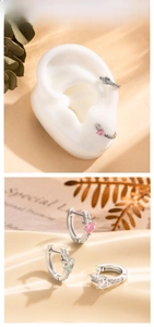 Detail of heart-shaped zircon huggie earrings with side micro-pave setting in 925 silver