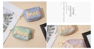 Close-up of glitter sequin mini coin purses with LOVE embroidery and gold keychains