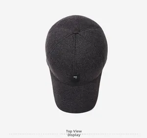 Top view of dark grey winter baseball cap with thick fabric texture and square label