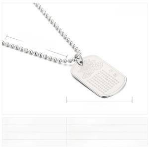 Close-up of engraved lotus and Buddhist Heart Sutra on stainless steel dog tag pendant